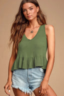 Sleeveless top with a triangle chest opening and a ruffled hem