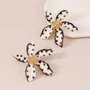 A wonderful summer earring in the shape of a dotted flower decorated in gold