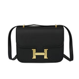 Square crossbody bag with gold button