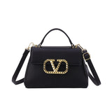 Small solid-color leather crossbody bag with an elegant gold V-button closure