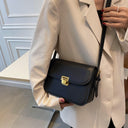 Solid-colored leather square crossbody bag with gold locking button