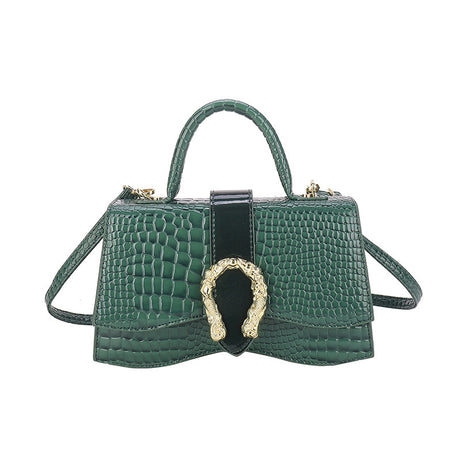 Small handbag in shiny snakeskin pattern with a solid color wavy bottom and a button strap closure
