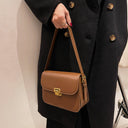 Solid-colored leather square crossbody bag with gold locking button