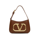 Solid color leather handbag with a large gold logo and an additional shoulder strap