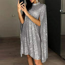Elegant, short, sparkling sequin evening dress with a round neck and cape sleeves